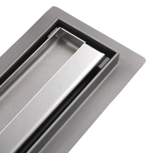 Reversible Revers grate of the Luxdrain STR, lifted above the channel